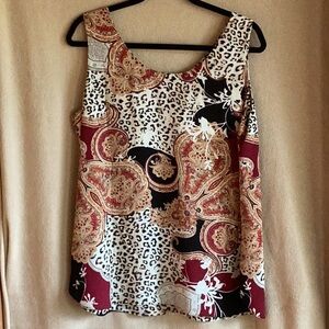 Sleeveless blouse with mixed print and reversible to all leopard print.   Size L